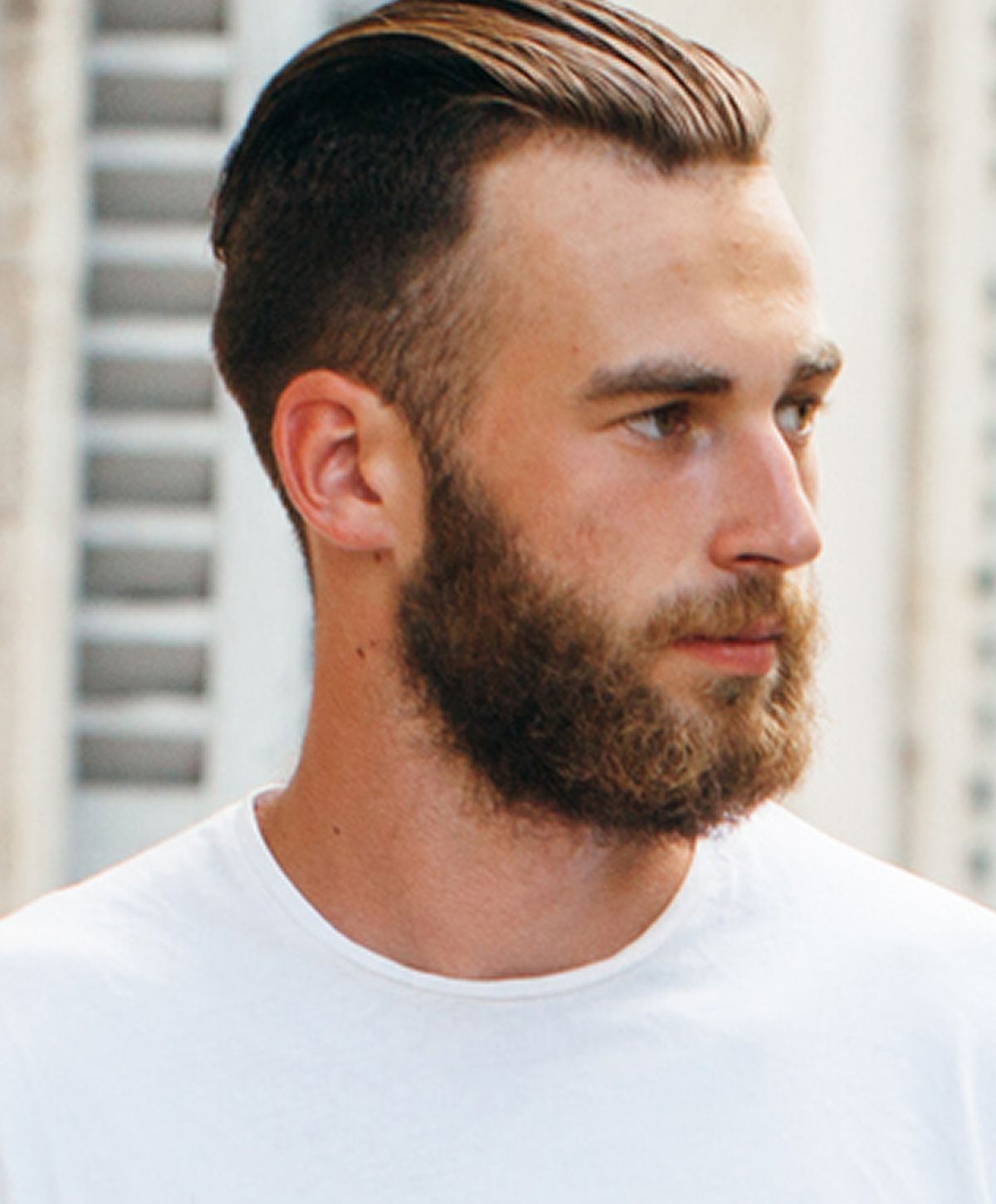Young woman with long, wavy hair smiling gently.