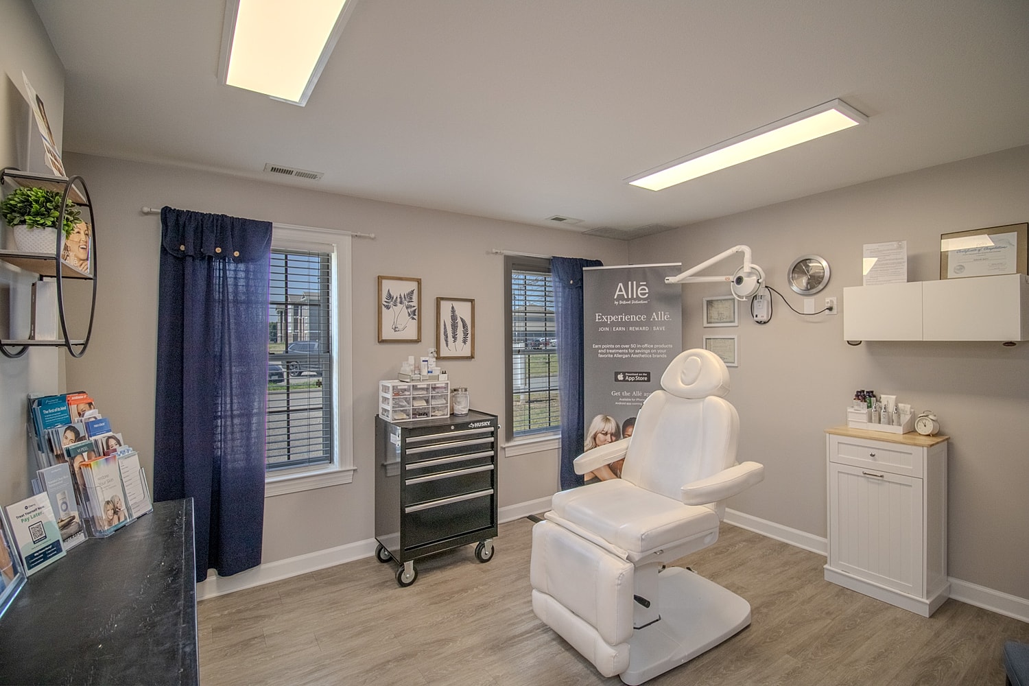 Aesthetic treatment room with white chair and decor.