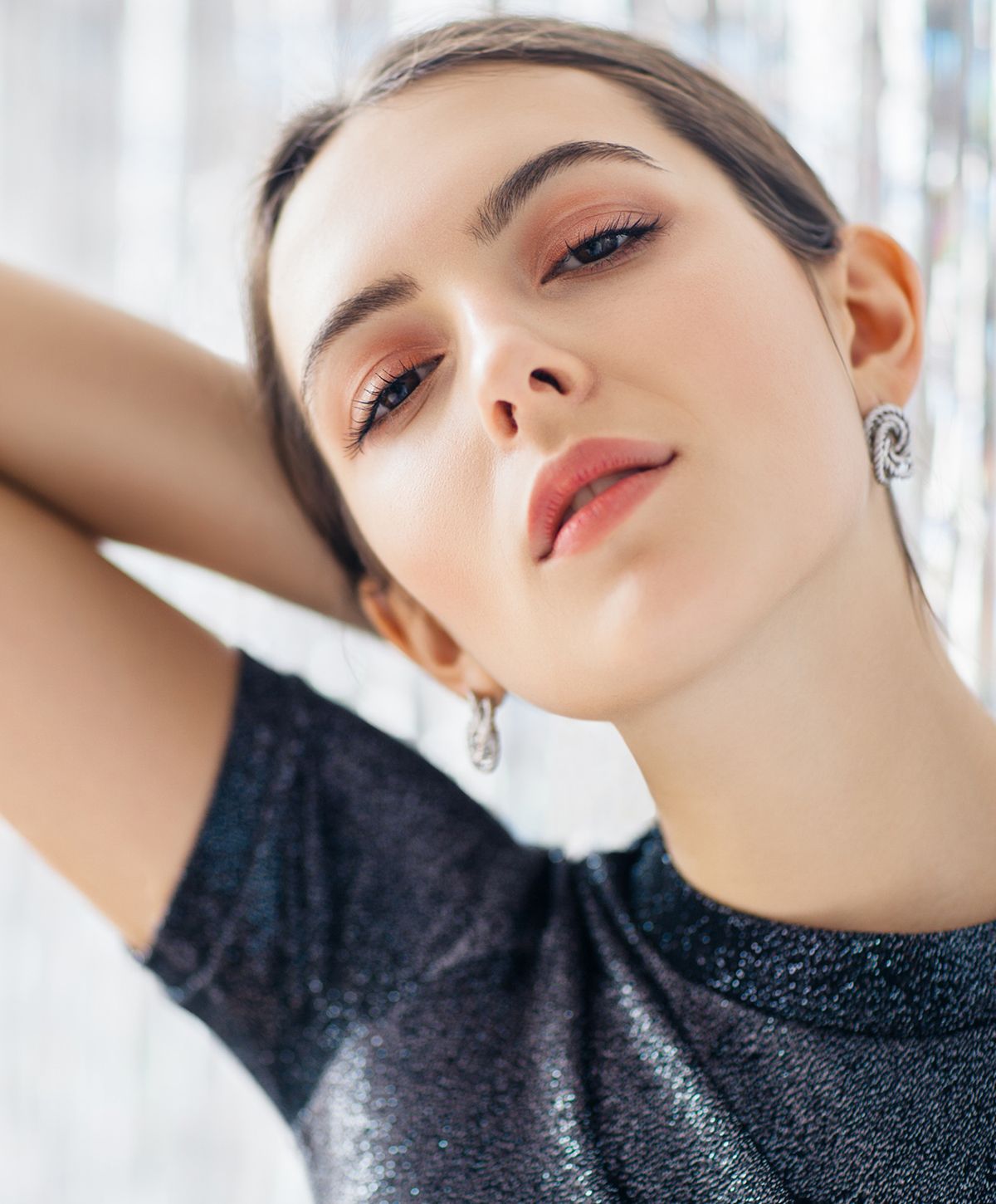 Suffolk benign mole removal model with elegant earrings.