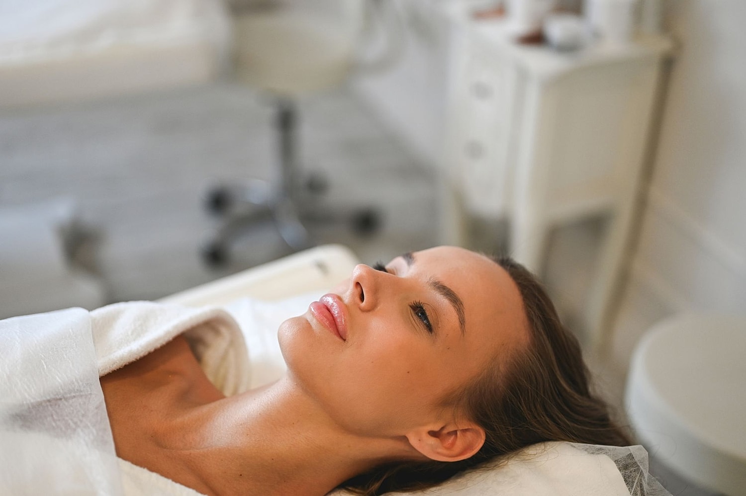 Woman relaxing during a facial treatment.