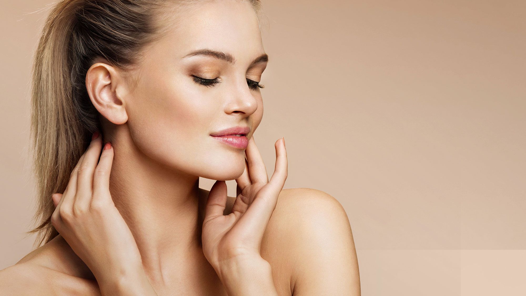 Woman with smooth skin and naturally styled hair.