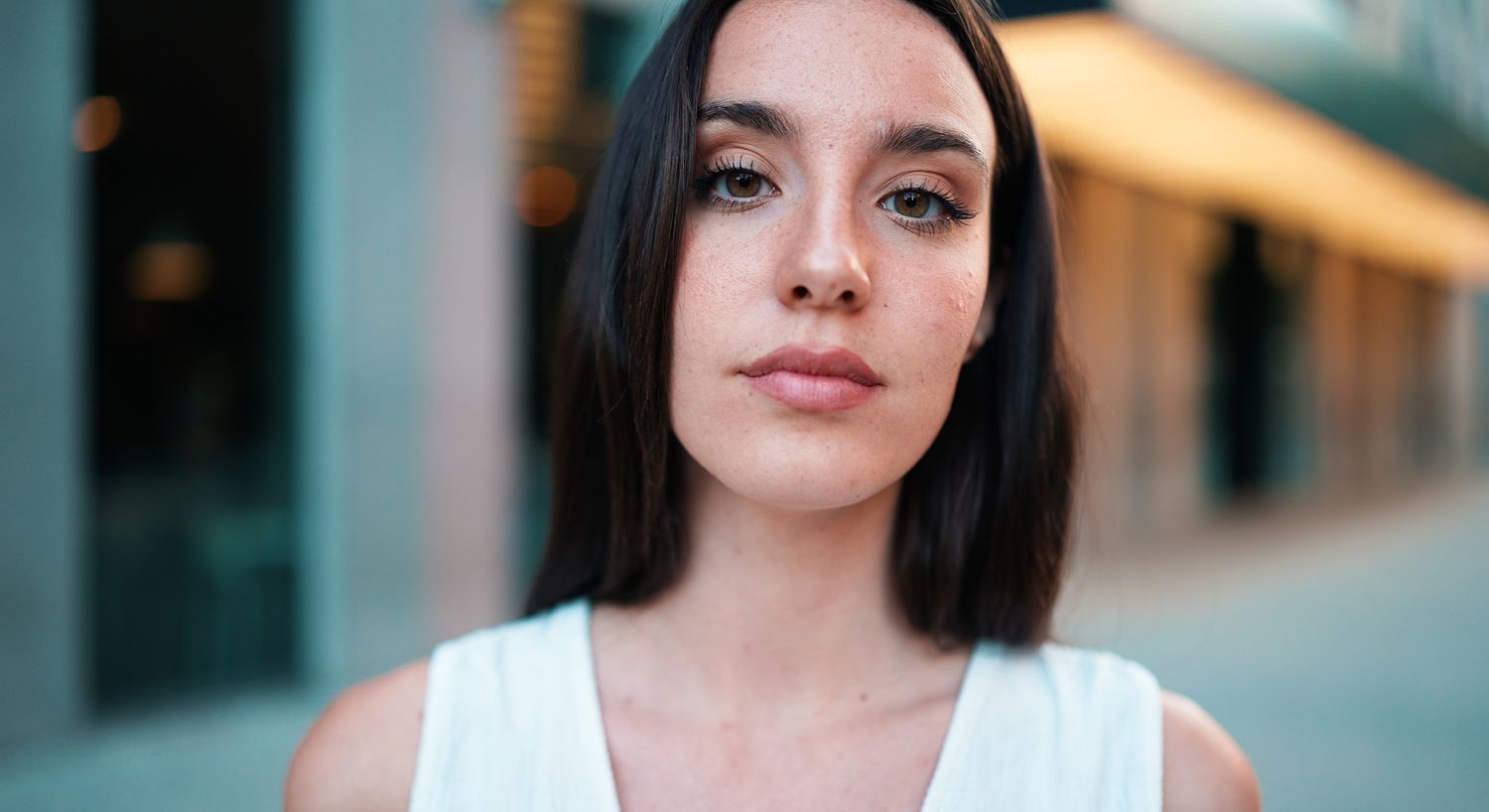 Smiling woman with hand on her face.