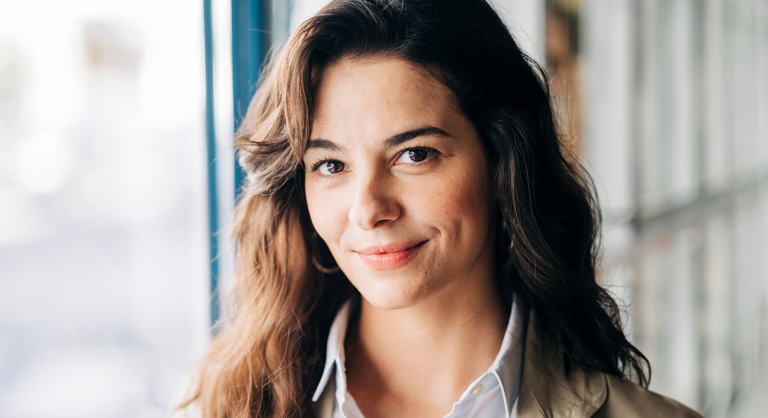 Smiling woman with long hair, indoors.