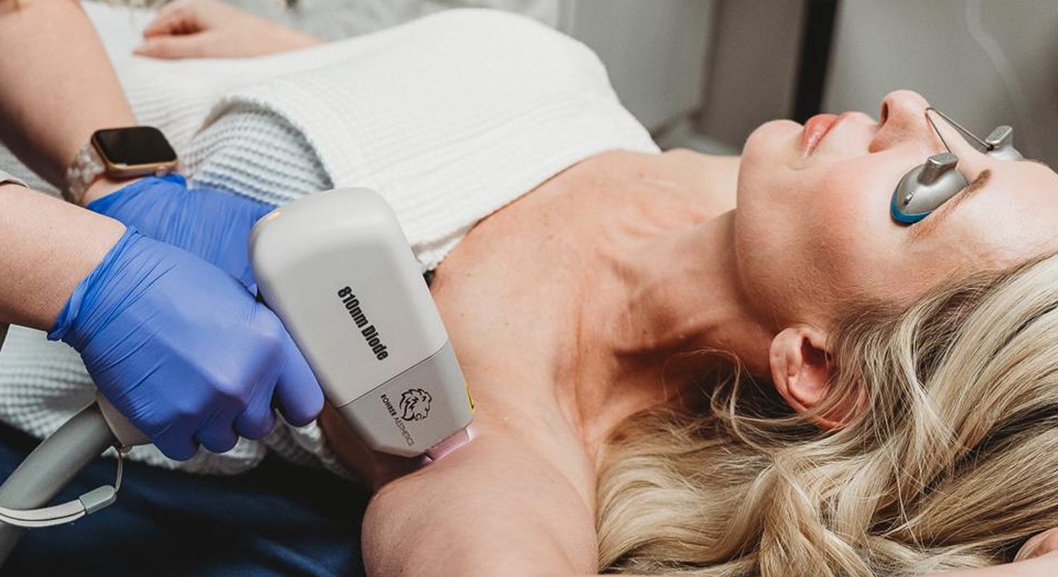 Laser treatment session on a woman's arm.